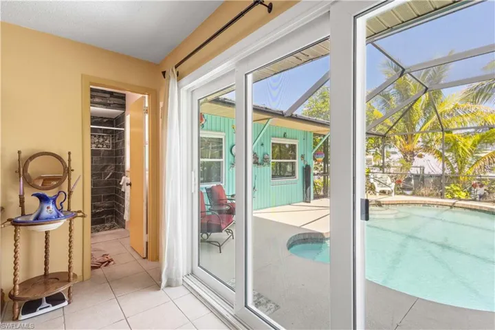 Doorway to outside featuring a sunroom and tile patterned floors