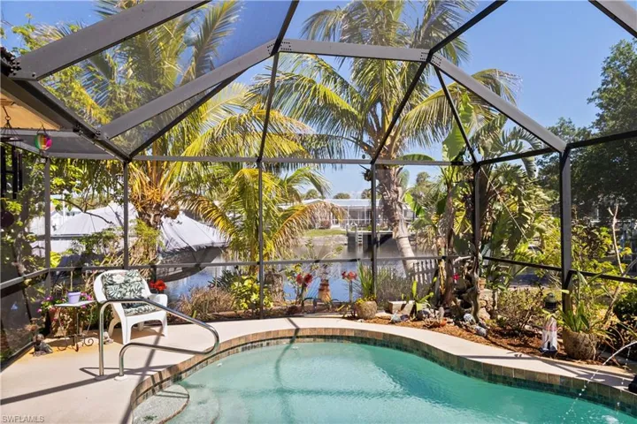 Swimming pool featuring a sunroom and glass enclosure