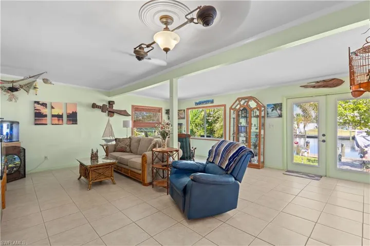 Living room featuring french doors and light tile patterned floors