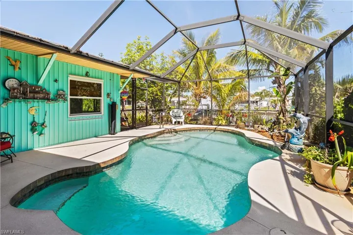 Swimming pool with glass enclosure, a sunroom, and a patio area