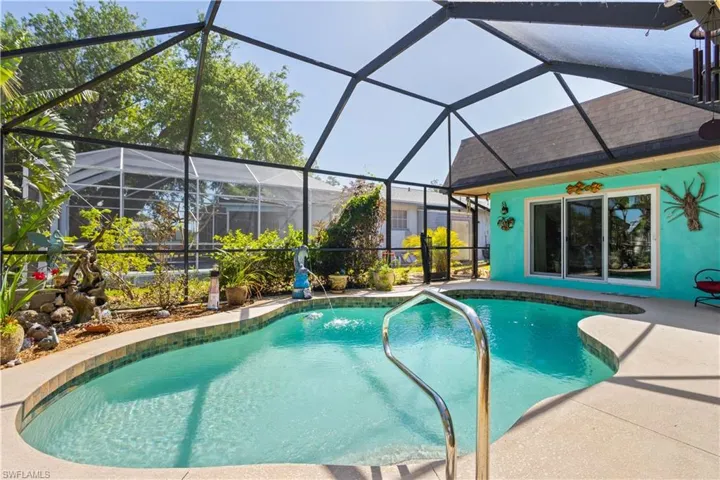 Outdoor pool featuring a lanai, a sunroom, and a patio