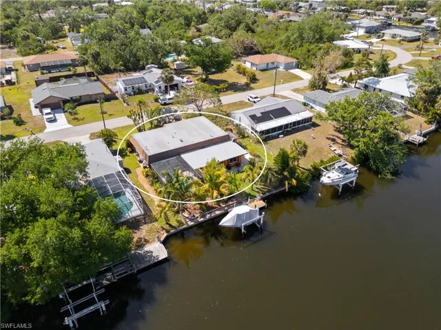 Aerial perspective of suburban area featuring a nearby body of water