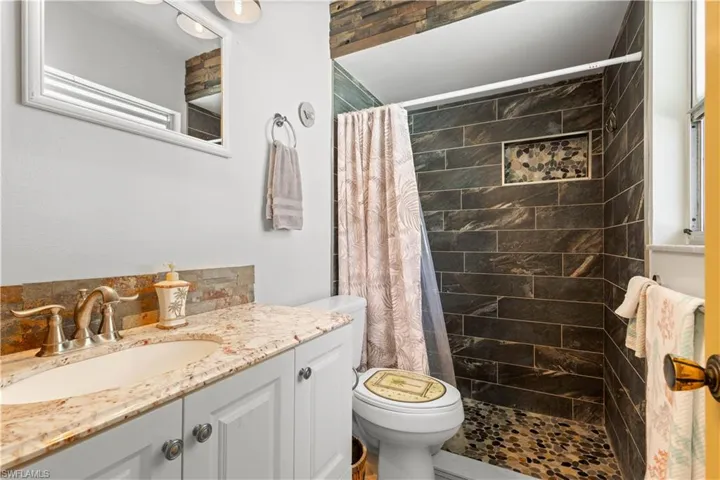 Bathroom featuring a stall shower and vanity