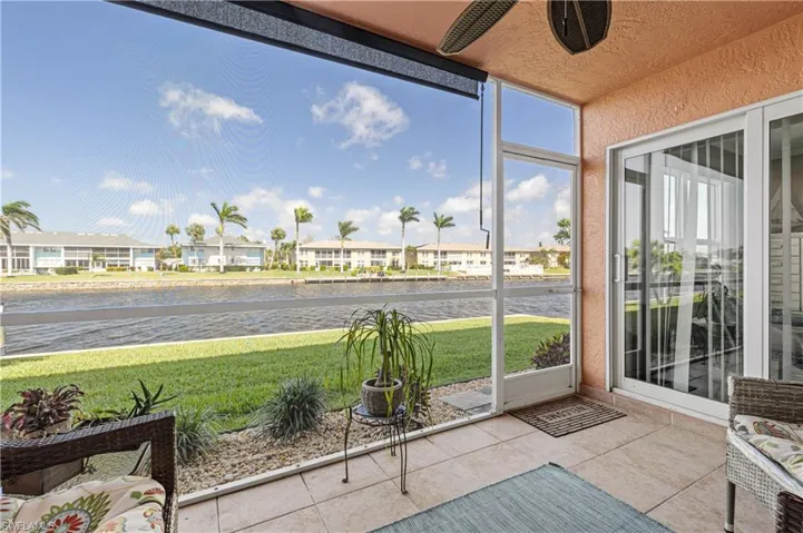 Screened in lanai featuring a water view