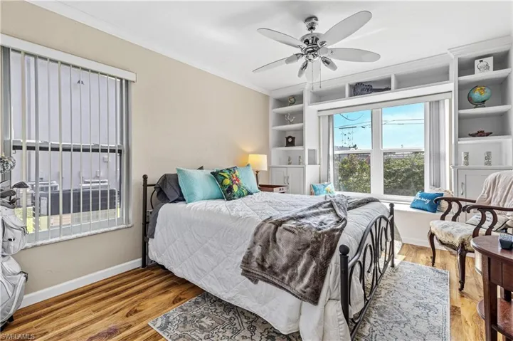 2nd Bedroom with crown molding, baseboards, ceiling fan, and wood finished floors