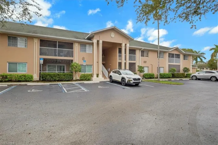 View of property with uncovered parking
