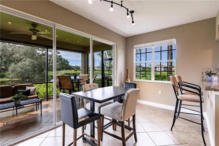 Dining space featuring light tile patterned floors and ceiling fan