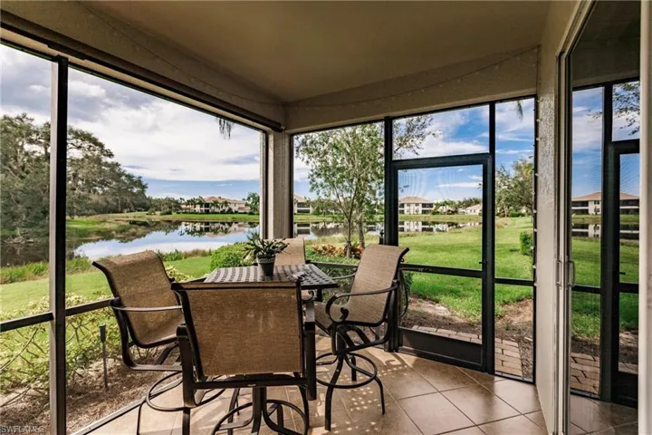 Sunroom featuring a water view and plenty of natural light
