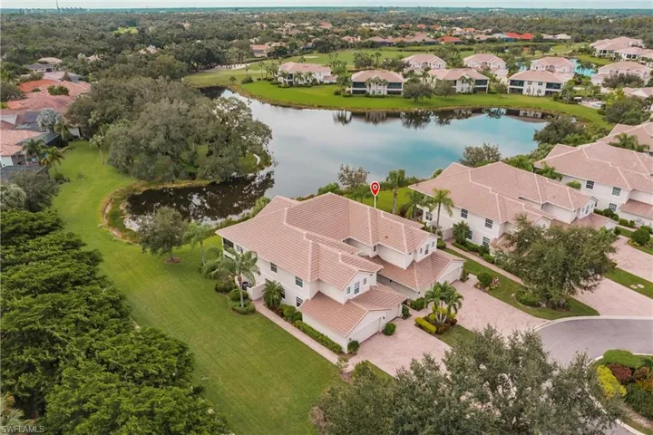 Aerial view of residential area featuring a nearby body of water