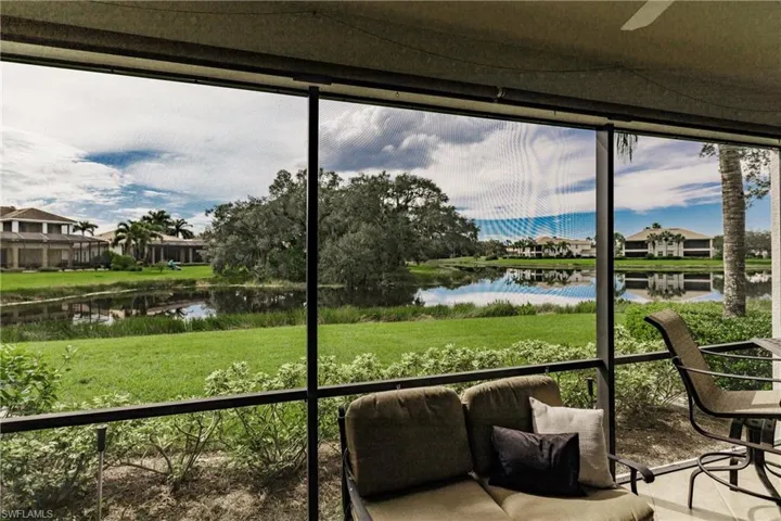 Sunroom featuring a water view