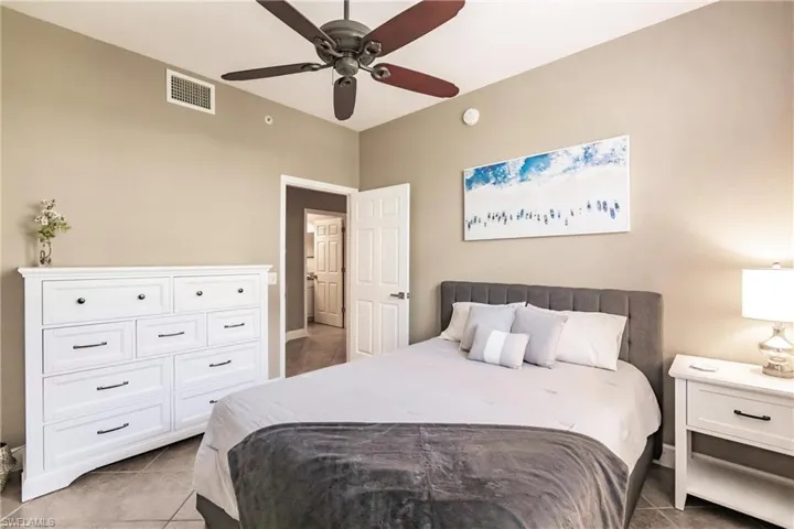 Bedroom with light tile patterned flooring and a ceiling fan
