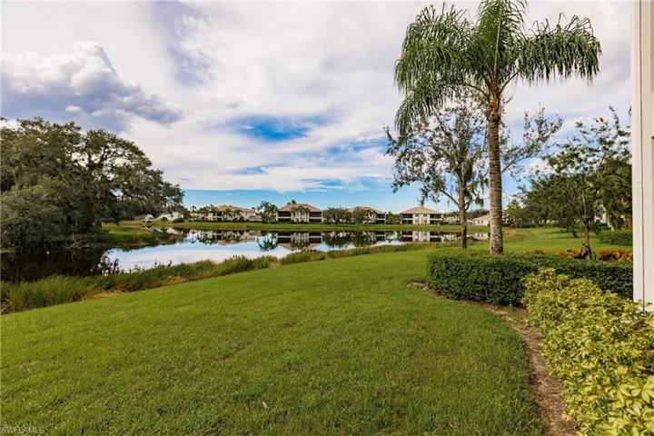 View of grassy yard with a water view