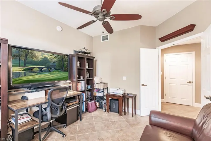 Office featuring light tile patterned flooring and ceiling fan