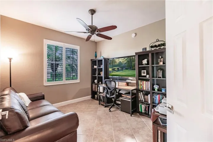 Office space with light tile patterned flooring and ceiling fan