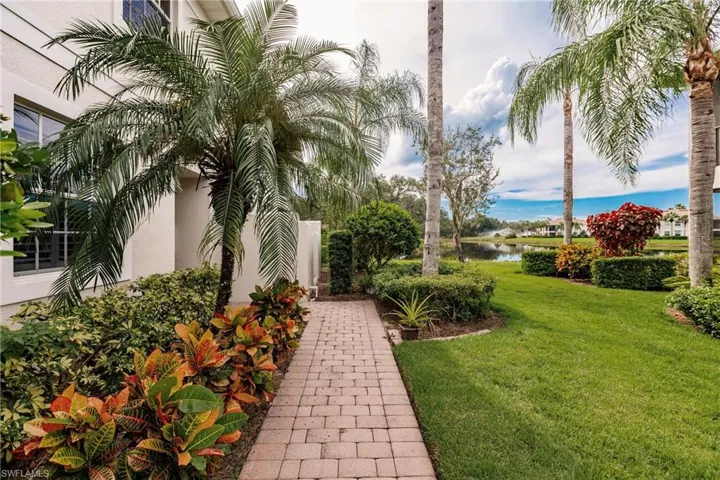 View of green lawn featuring a water view