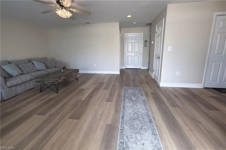 Unfurnished living room featuring ceiling fan, wood finished floors, and recessed lighting
