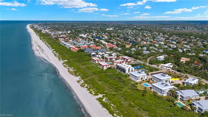 Drone / aerial view with a view of the beach and a water view