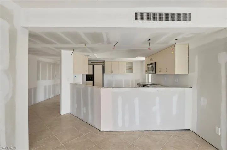 Kitchen featuring cream cabinetry and light tile patterned floors