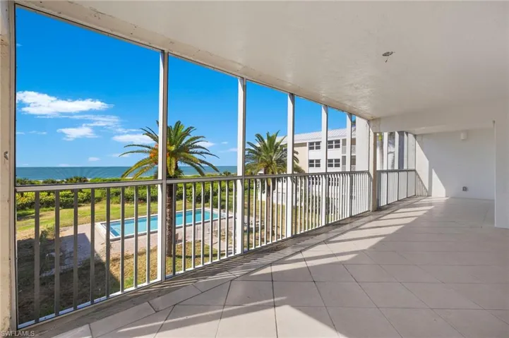 Balcony featuring a water view and a fenced in pool