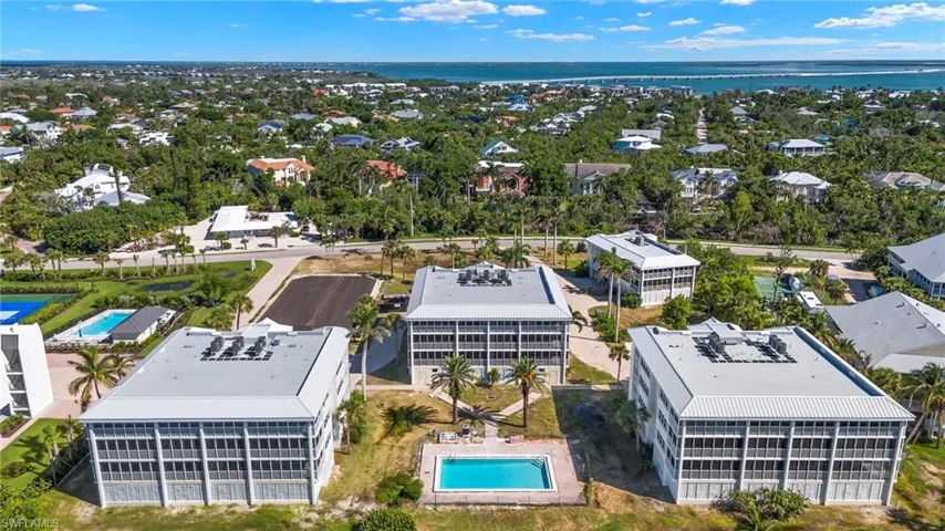 Birds eye view of property with a water view