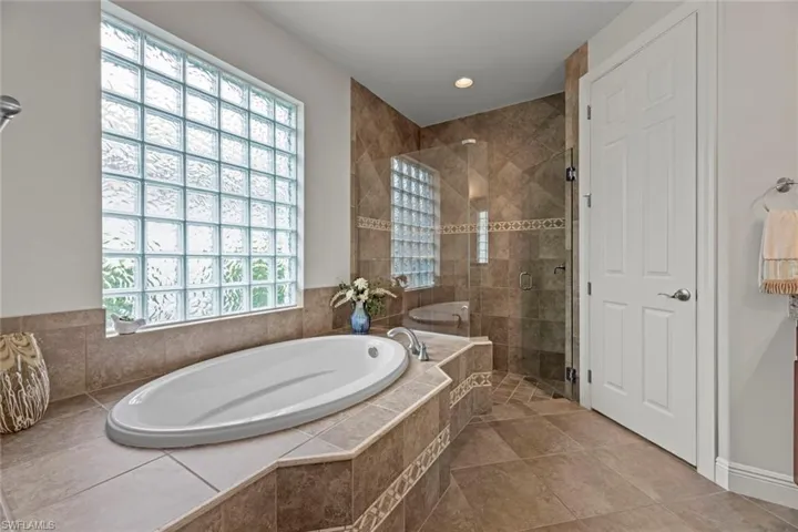 Master en-suite has large walk-in shower and soaking tub