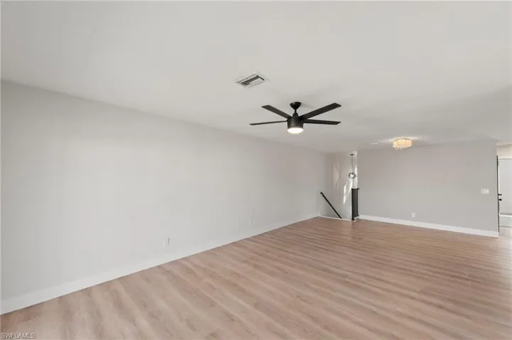 Empty room featuring light wood finished floors and ceiling fan