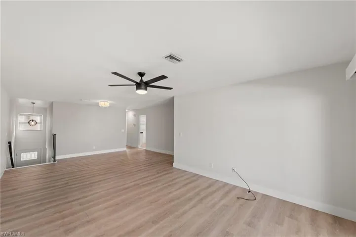Spare room featuring a ceiling fan and light wood-style floors