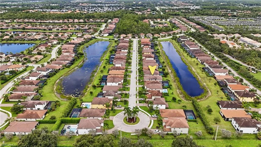 Aerial overview of a residential community featuring multiple water elements