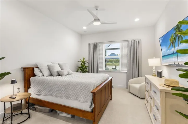 Bedroom featuring light carpet, a ceiling fan, and recessed lighting