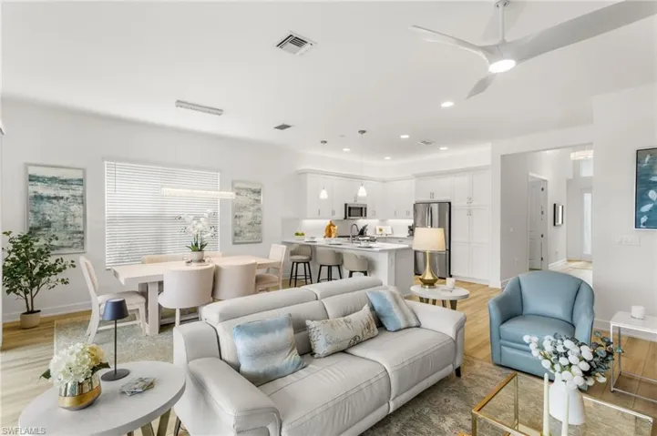 Living area with light wood finished floors, ceiling fan, and recessed lighting