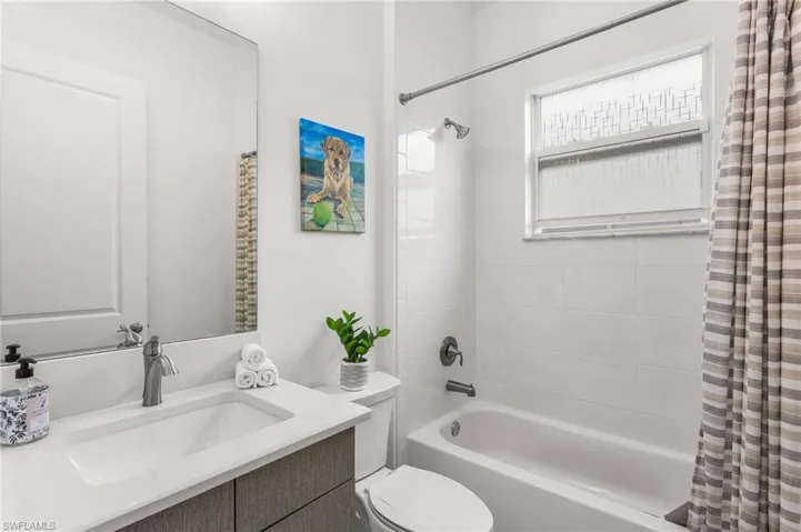 Bathroom with vanity and shower / tub combo