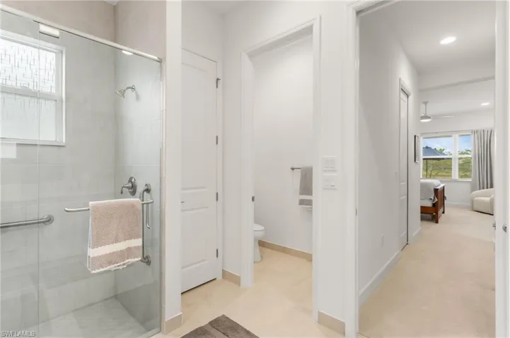 Ensuite bathroom featuring a shower stall and recessed lighting