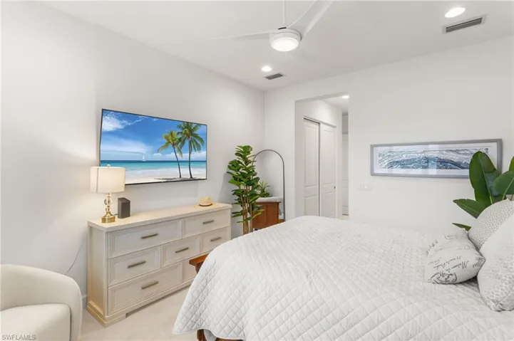 Bedroom with light colored carpet, ceiling fan, a closet, and recessed lighting