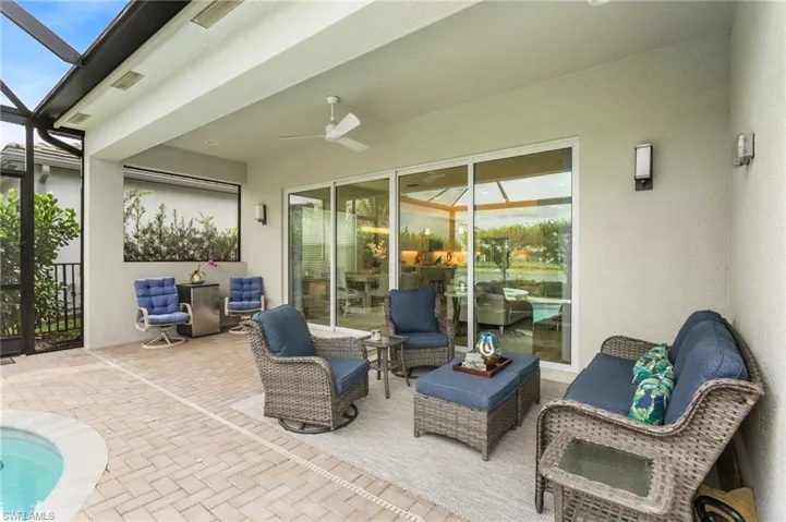 View of patio / terrace with glass enclosure, a ceiling fan, an outdoor pool, a sunroom, and an outdoor hangout area