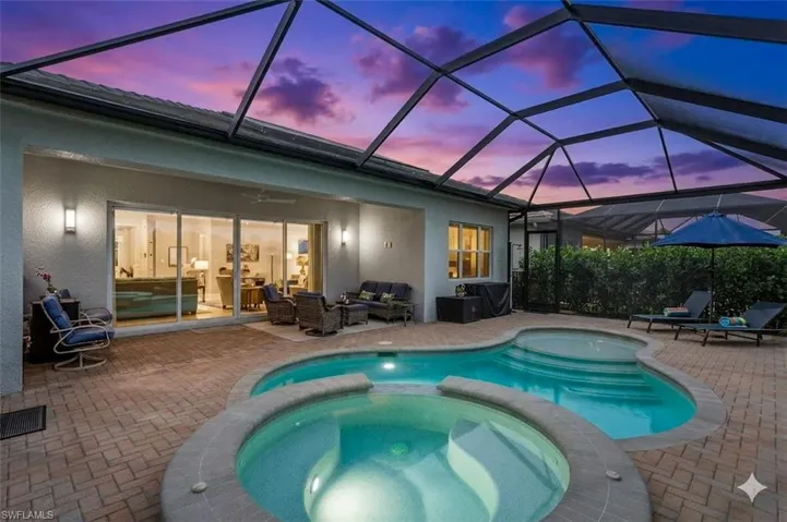 Integrated pool / spa featuring a sunroom, a lanai, a patio, and an outdoor living space