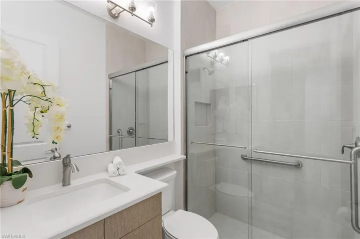 Bathroom with vanity and a shower stall