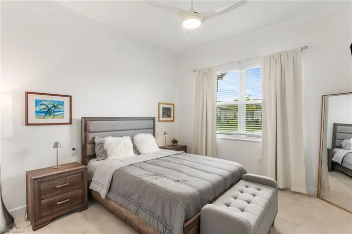 Bedroom featuring light colored carpet and ceiling fan