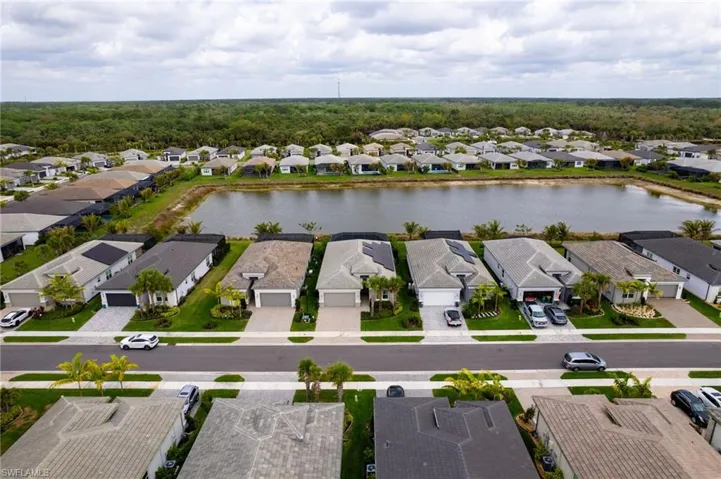 Aerial perspective of suburban area featuring a large body of water