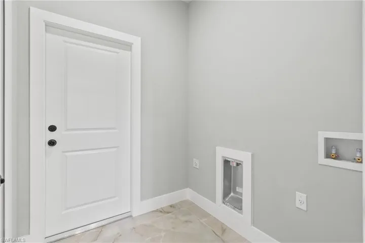 Laundry room featuring electric dryer hookup, washer hookup, and light marble finish floors