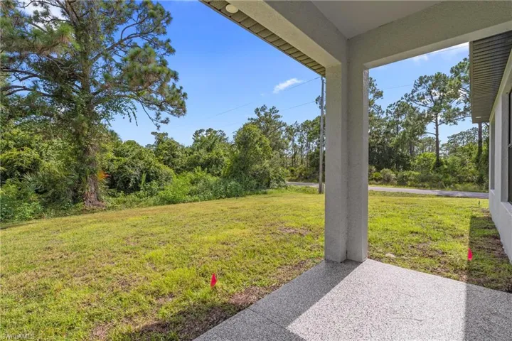 View of grassy yard with a patio