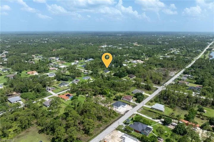 Aerial overview of property's location with nearby suburban area