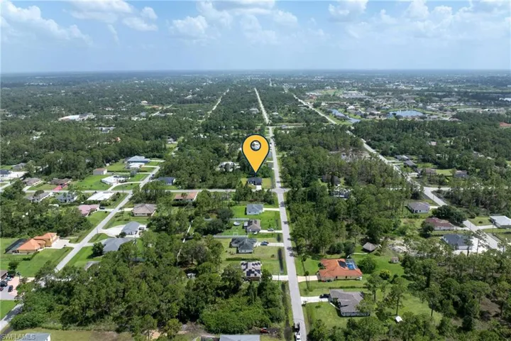Aerial overview of property's location featuring nearby suburban area