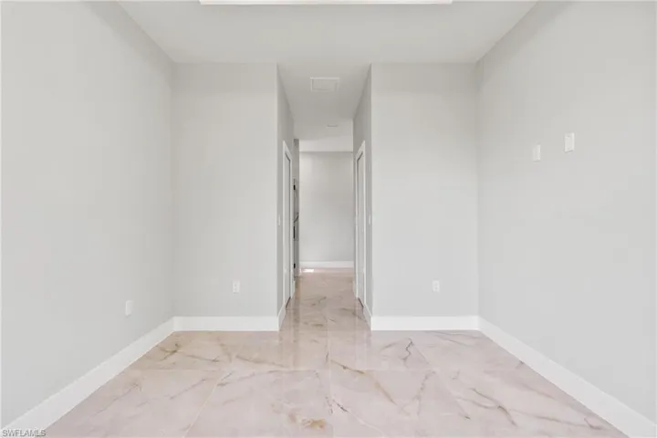 Empty room with baseboards and light marble finish floors