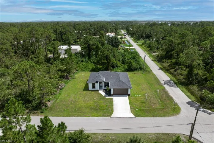 View from above of property featuring a heavily wooded area
