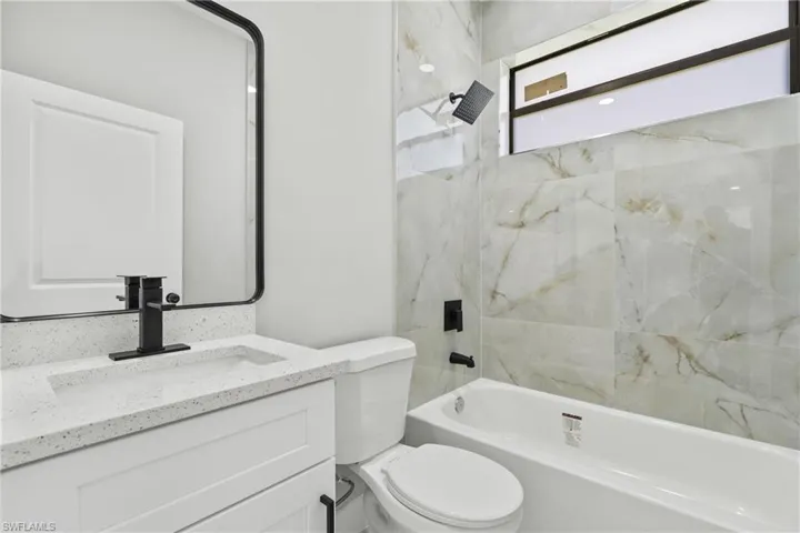 Bathroom with vanity and shower / bath combination