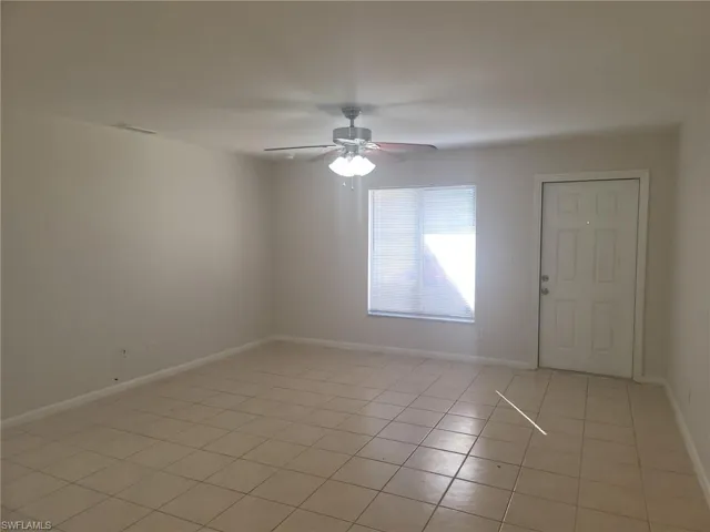 Unfurnished room with a ceiling fan and light tile patterned flooring