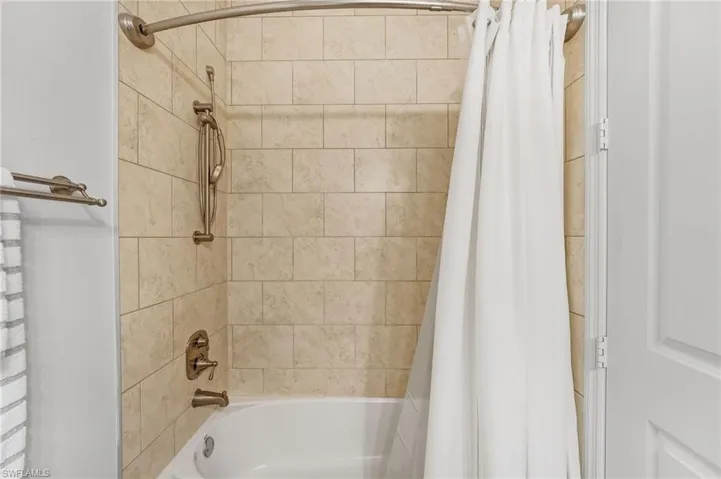 Private ensuite bath with a tub-shower combination, combining practicality with comfort.