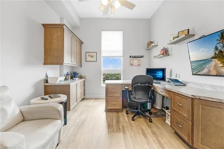 The versatile third bedroom is currently set up as an office, featuring a removable desk and additional flooring provided by the seller to seamlessly convert it back into a bedroom. Enjoy working while taking in stunning views.
