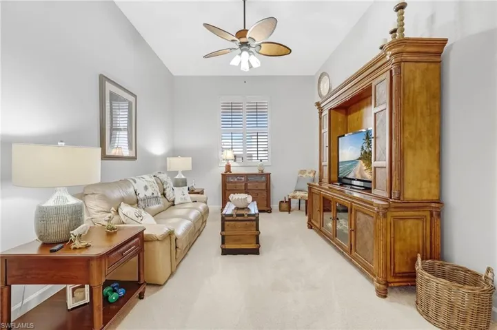 The spacious media room is adorned with plush carpeting and bathed in natural light, providing the perfect blend of comfort and style.