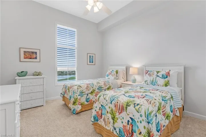 The well-appointed second bedroom is bathed in natural light, offers a sizable closet, and plush carpeting, creating a cozy and inviting retreat.